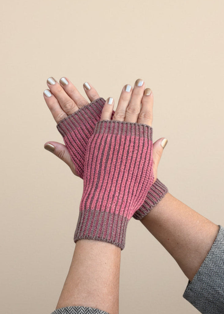 Hands with coral brioche gloves