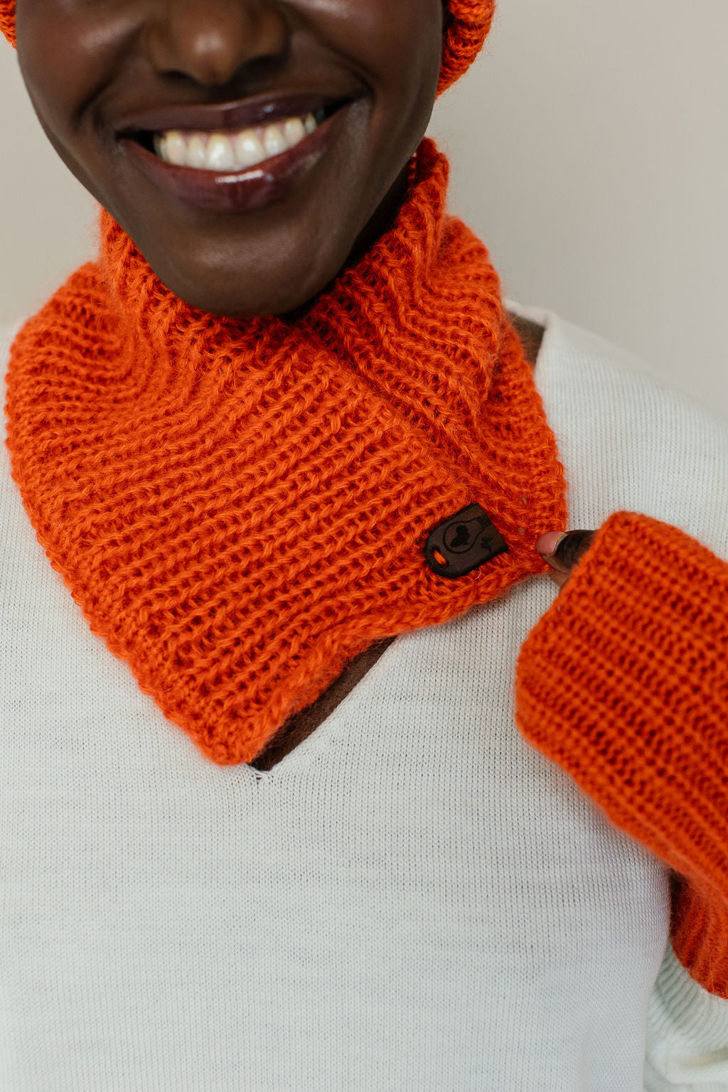 Woman with orange mohair neck warmer and gloves