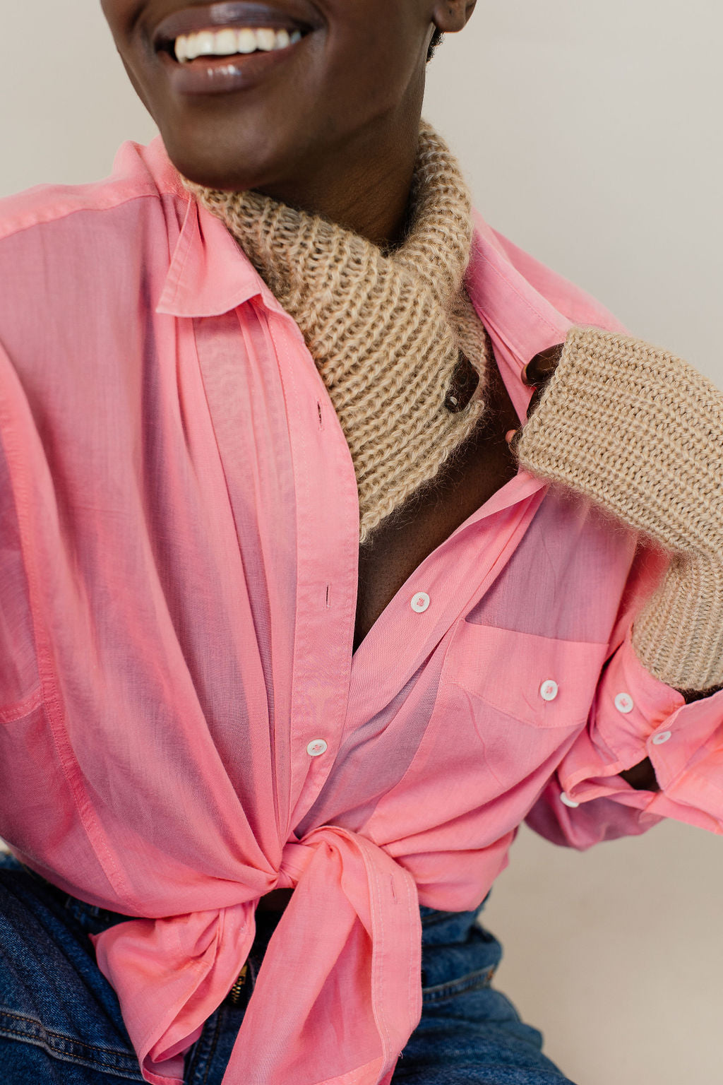 Woman in pink shirt wearing caramel mohair neck warmer and gloves