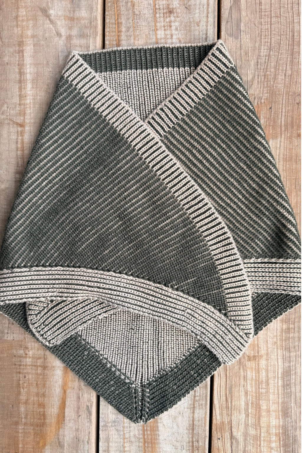 wool triangle scarf in brioche knit on wooden background