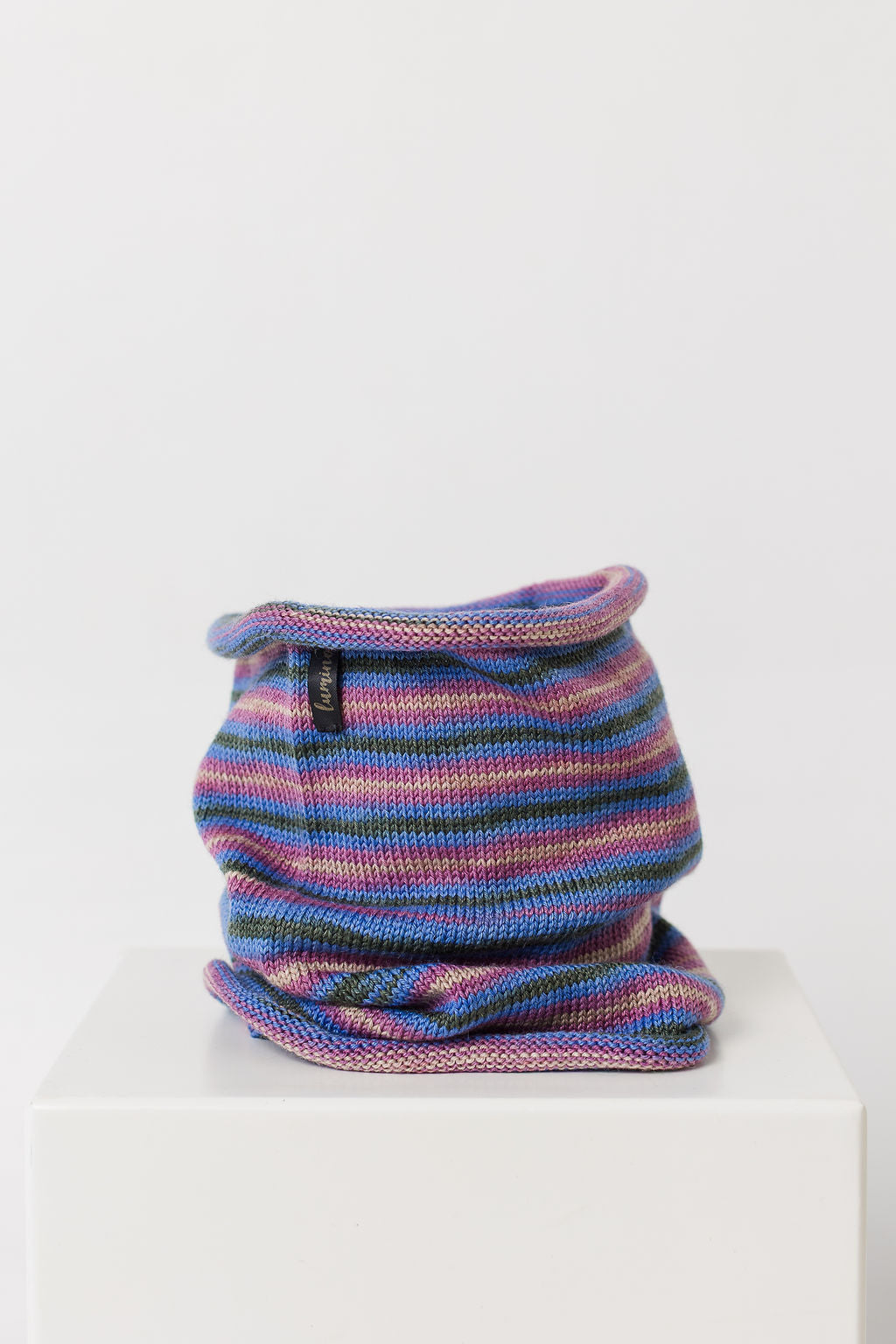 Multicolored knitted neck warmer on a white background
