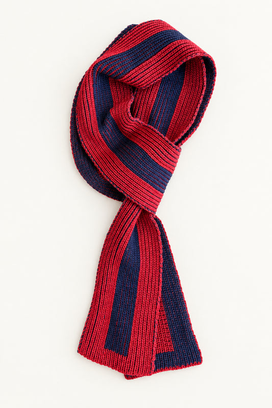 Red and navy striped scarf folded against plain background