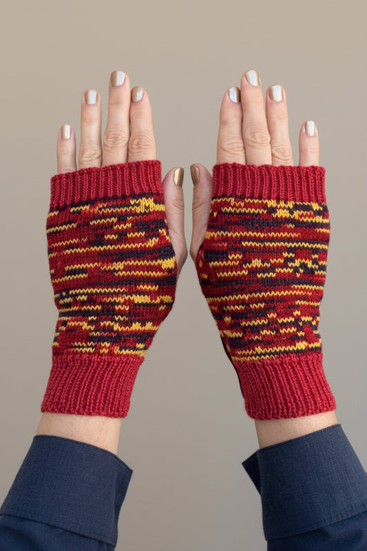Red and yellow striped fingerless gloves on a gray background