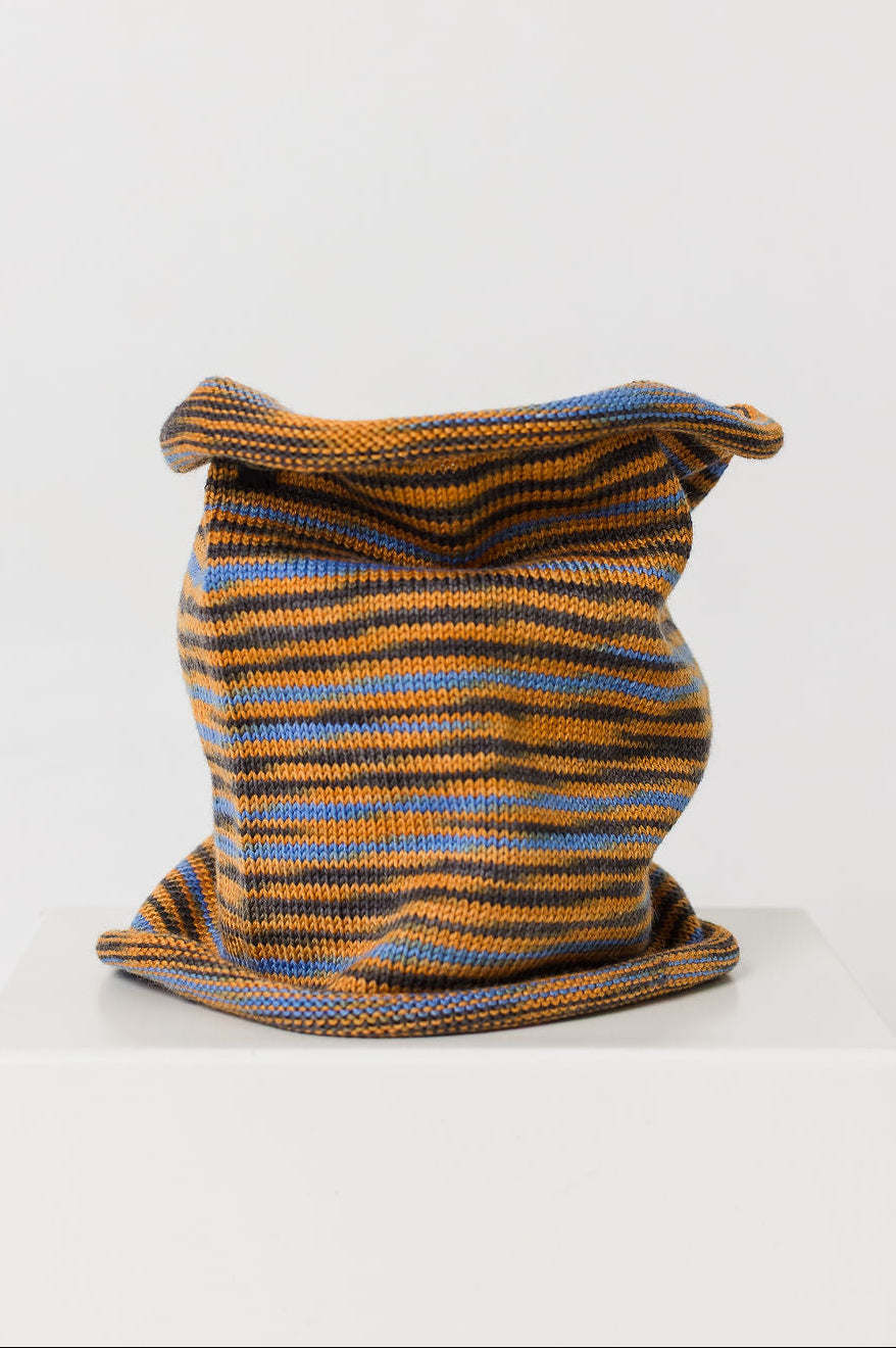 Knitted neck warmer with orange and blue stripes on a white background