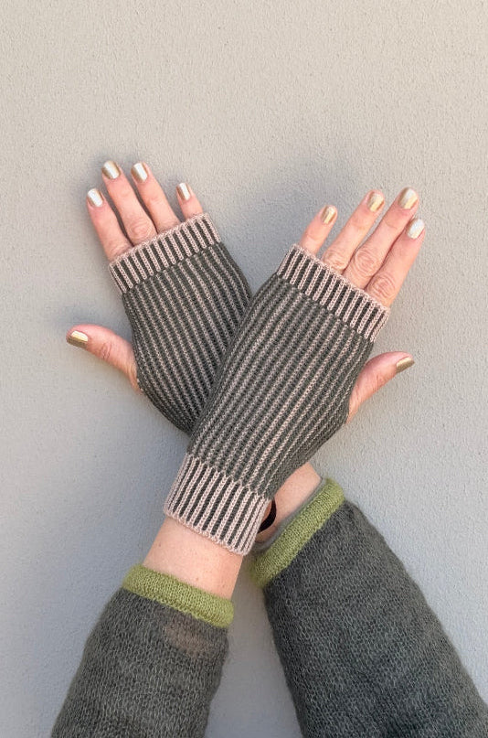 someone wearing sand and green brioche fingerless gloves against neutral background